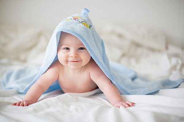 Baby on bed in blanket
